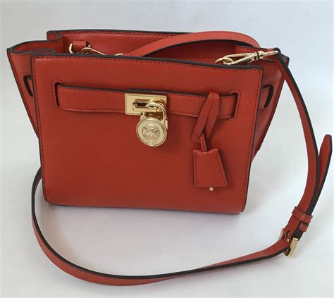 michael kors crossbody orange straps and orange side pouch|Michael Kors orange bag.